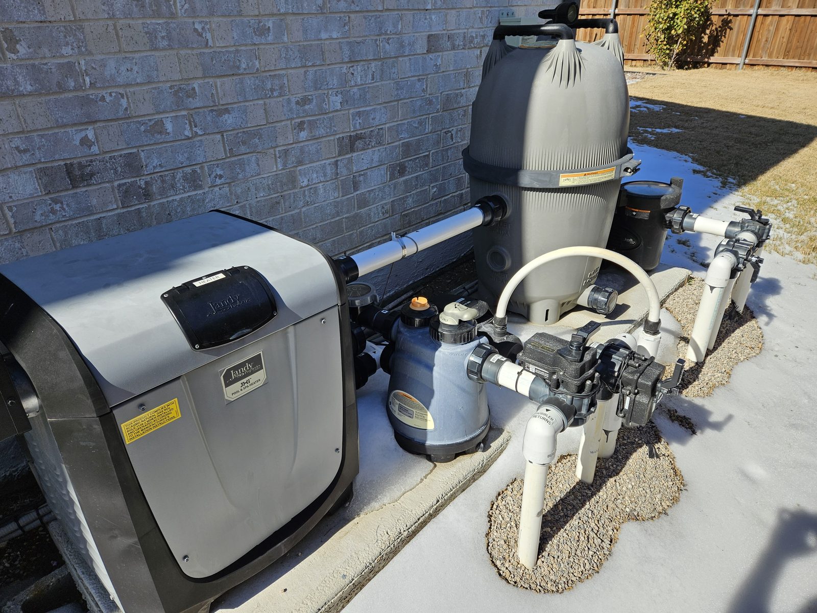 Pool heater installed on a McEwan Pools equipment pad