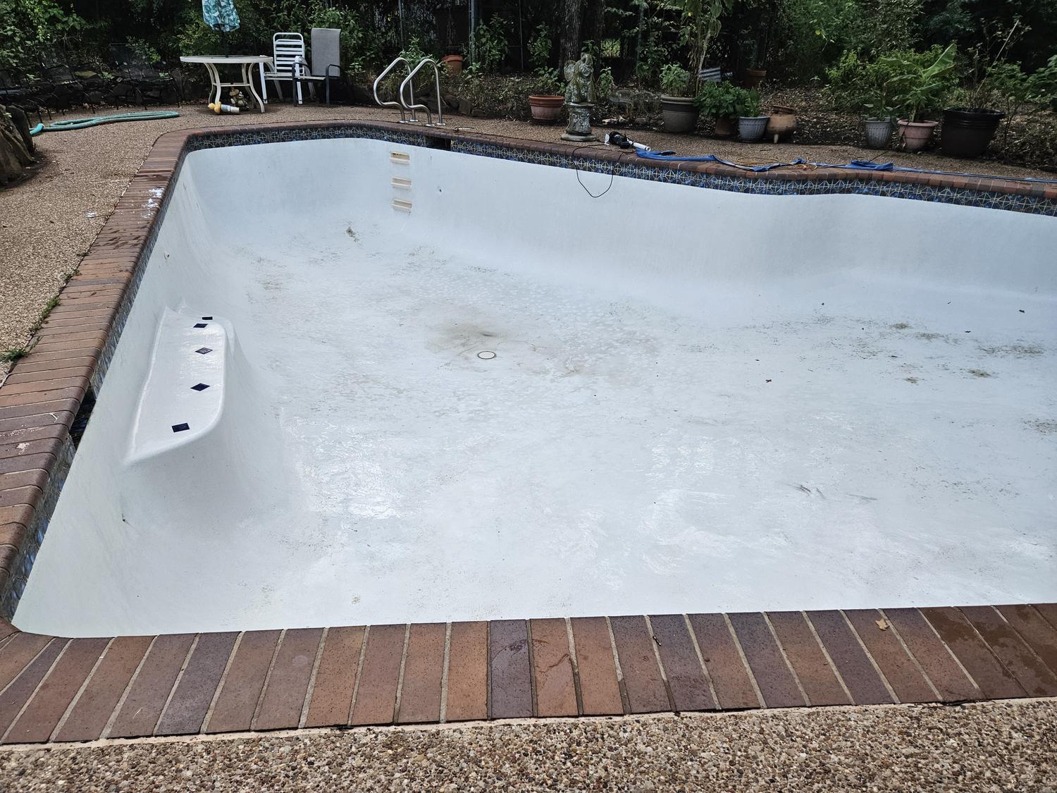 Empty pool shell in Mansfield part way through cleaning, waiting to be refilled