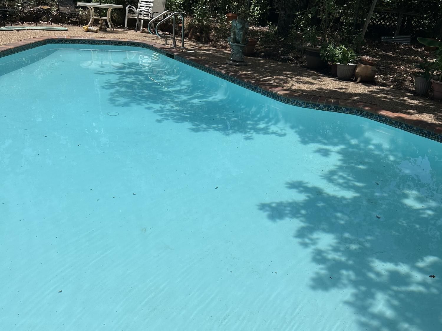 The same Mansfield pool refilled after cleaning, water clear and blue to the floor